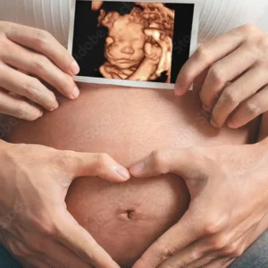 A person holding an image of a baby in the belly.